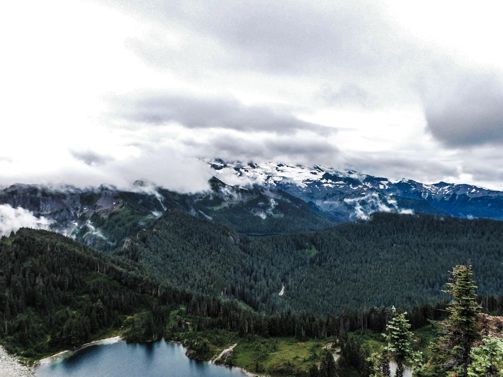 a view of a mountain range with a lake in the foreground