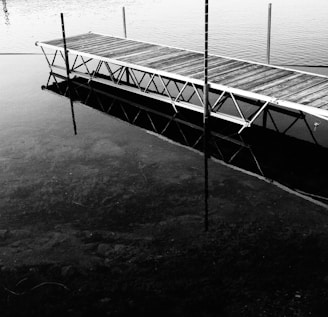 A close-up of a sturdy dock installation with calm water reflections.