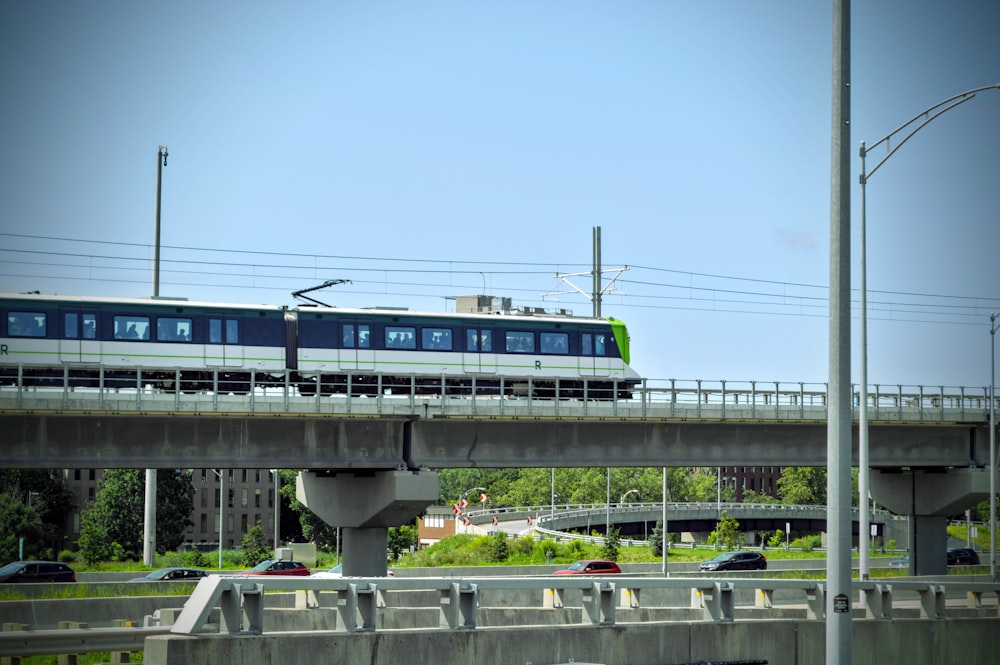 a train traveling over a bridge over a street