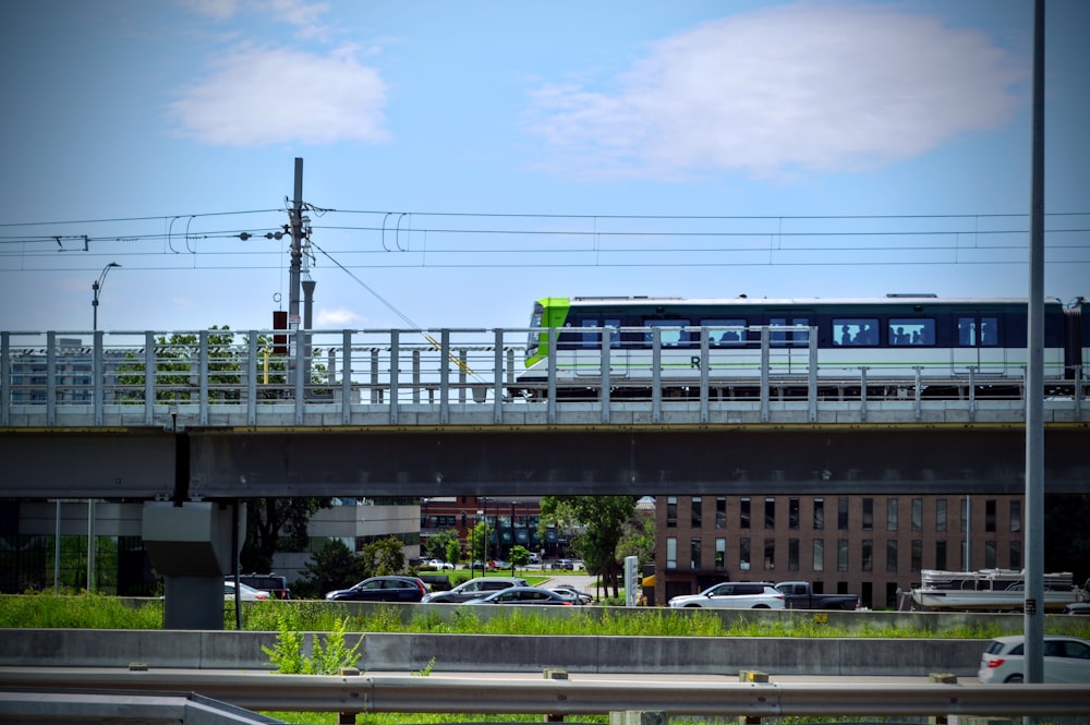 a train traveling over a bridge over a street