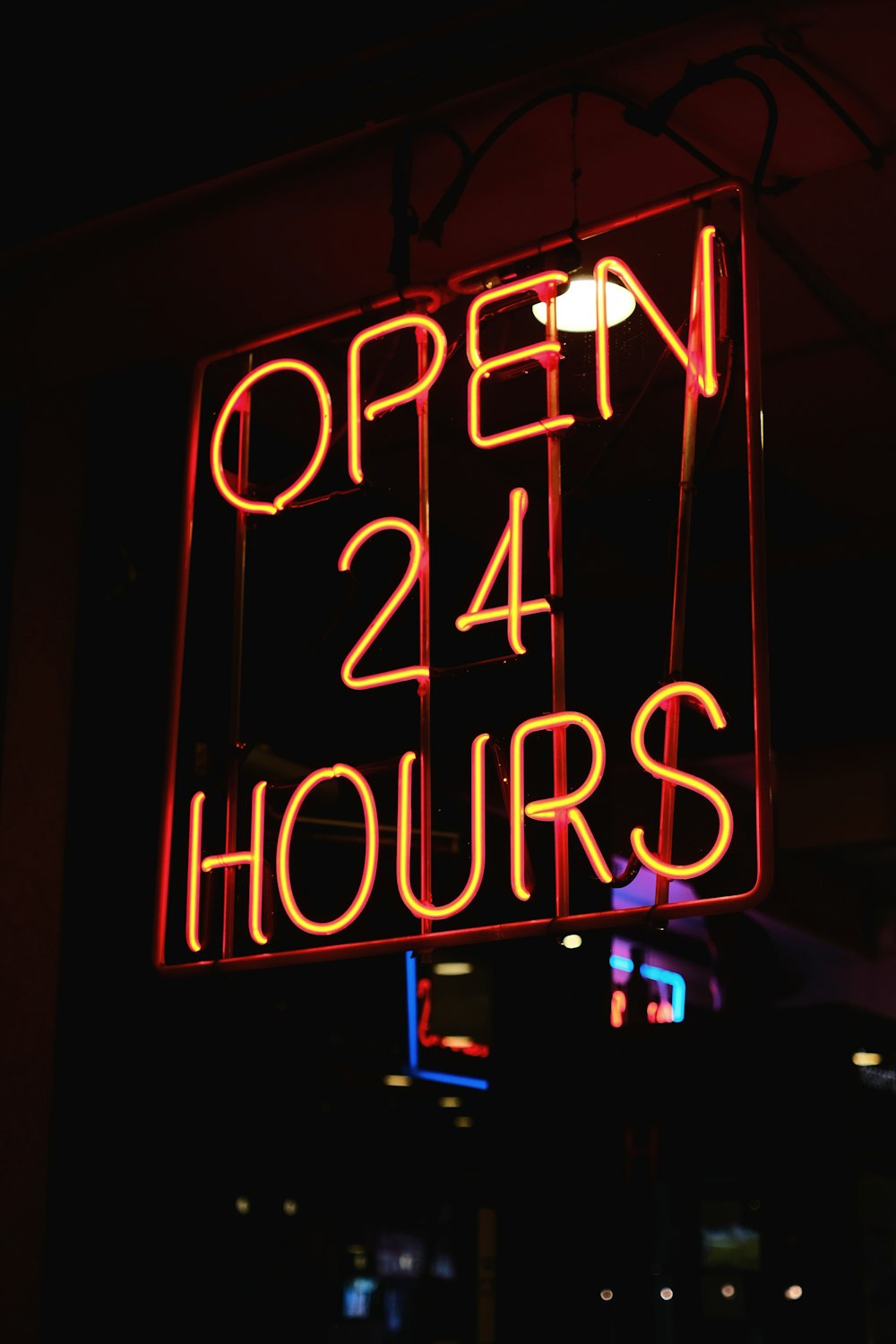 a neon sign that reads open 24 hours