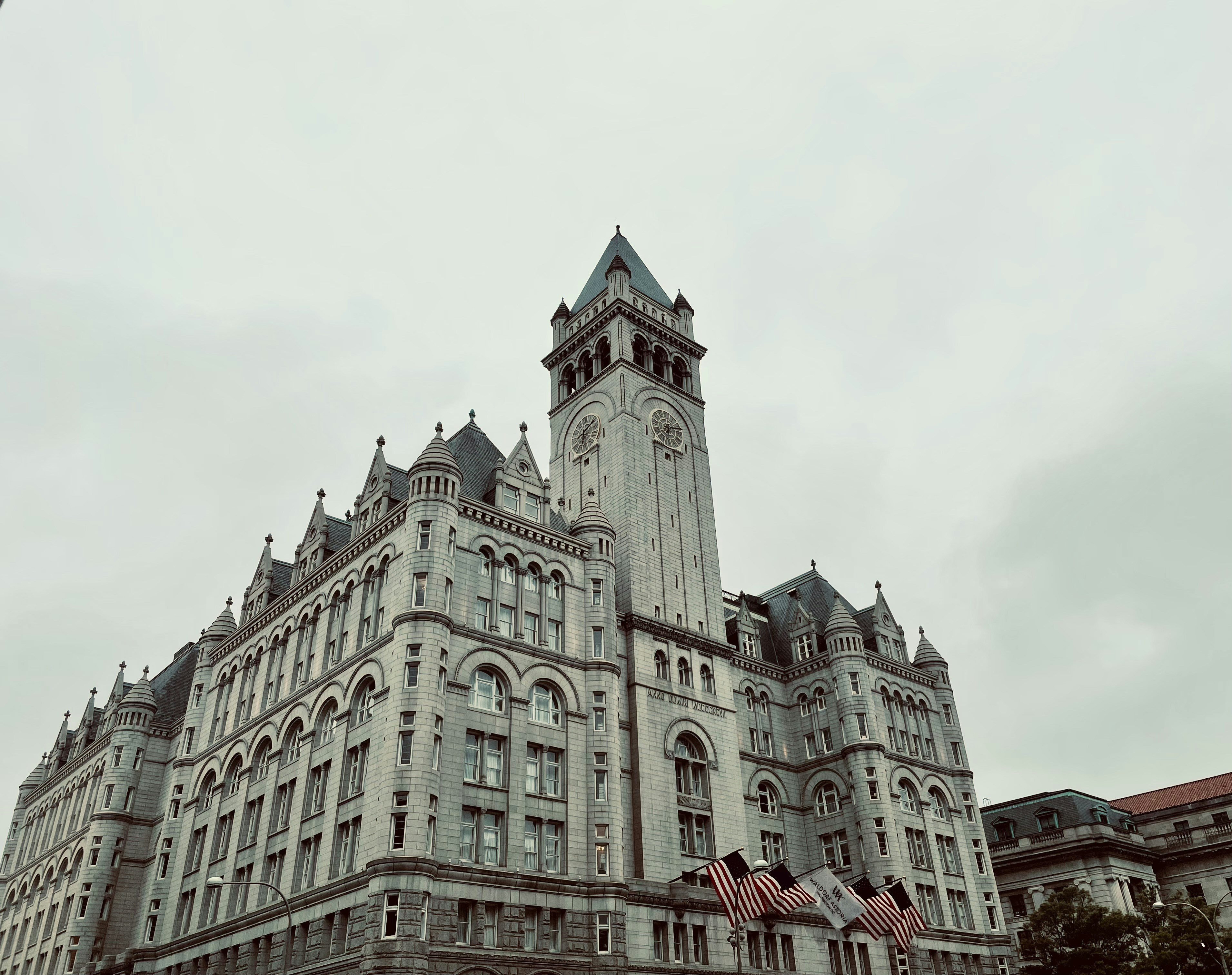 A large building with a clock on the top of it photo – Free ...