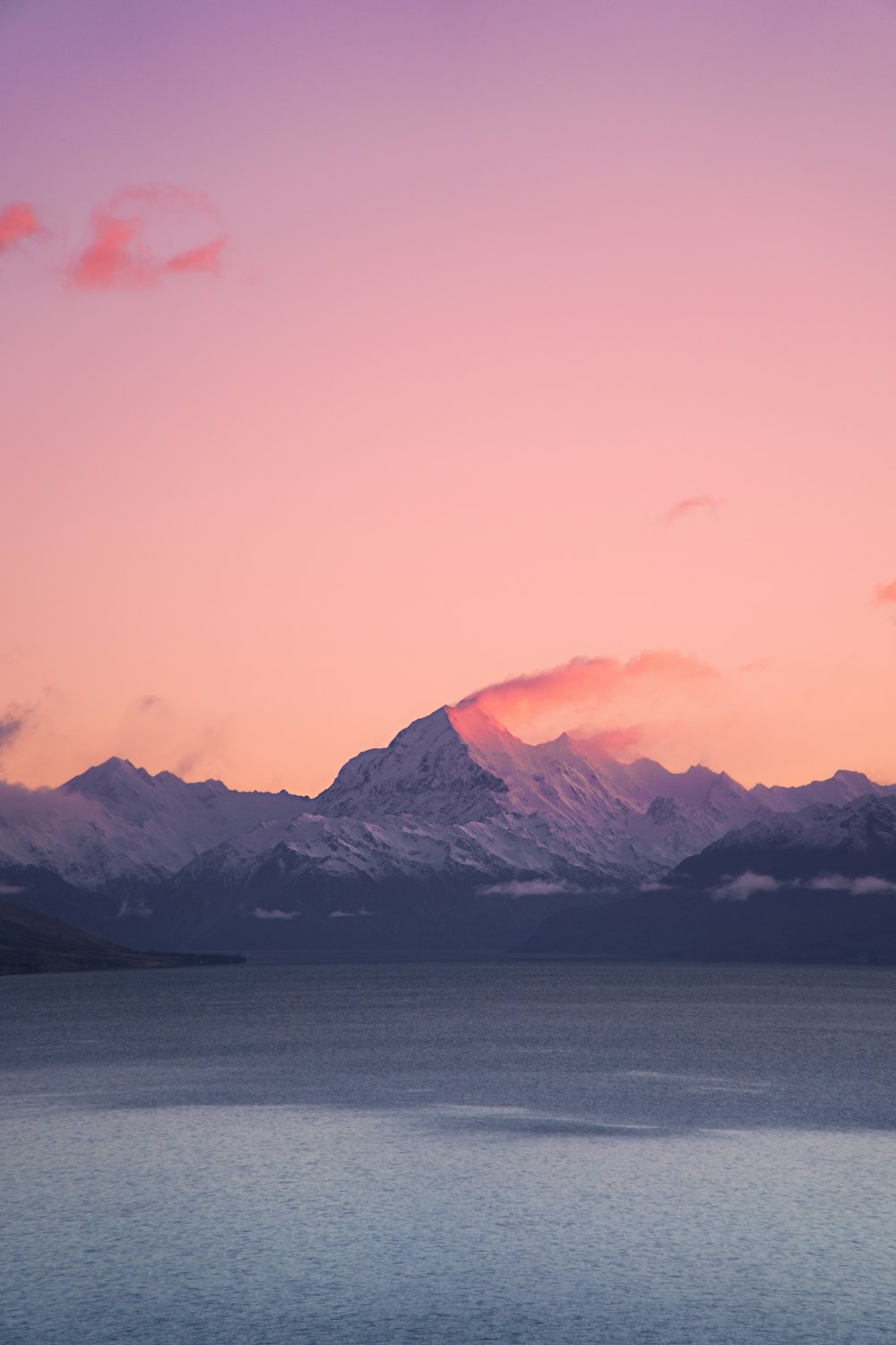 a large body of water with mountains in the background