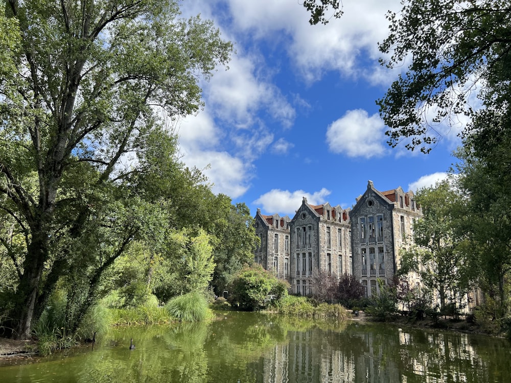 a large building sitting on top of a lush green forest