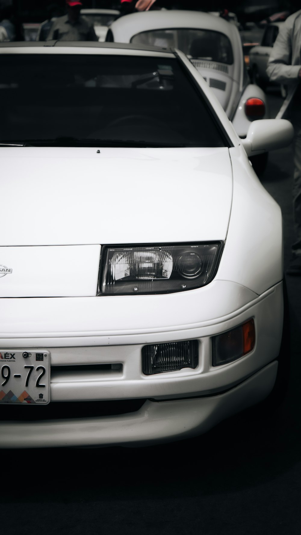 a white car parked in a parking lot next to other cars