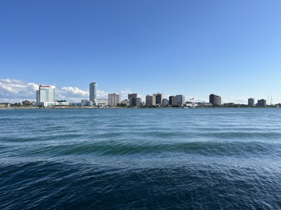 A scenic view of a Canadian city skyline with iconic landmarks under a clear sky.