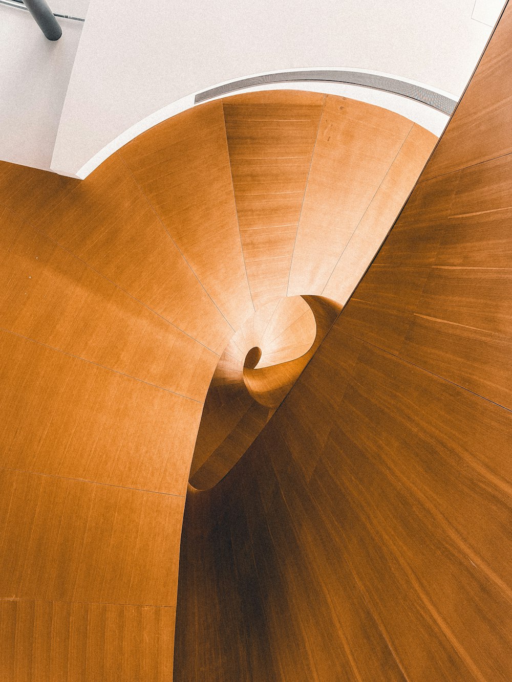 a wooden spiral staircase in a building