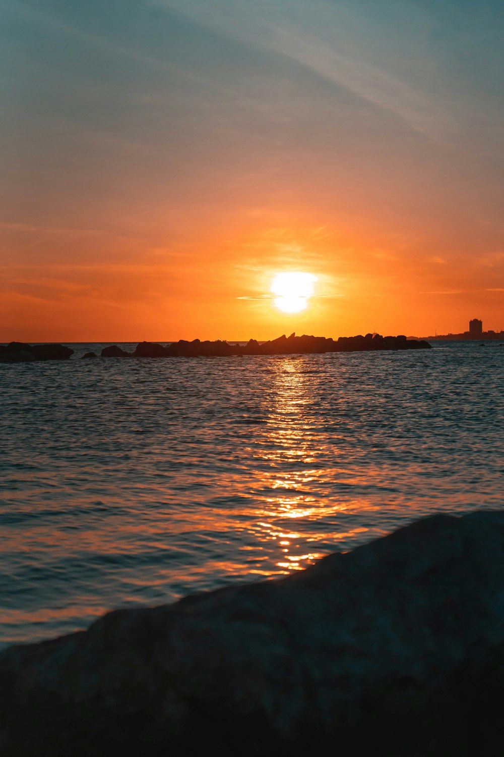 the sun is setting over a body of water