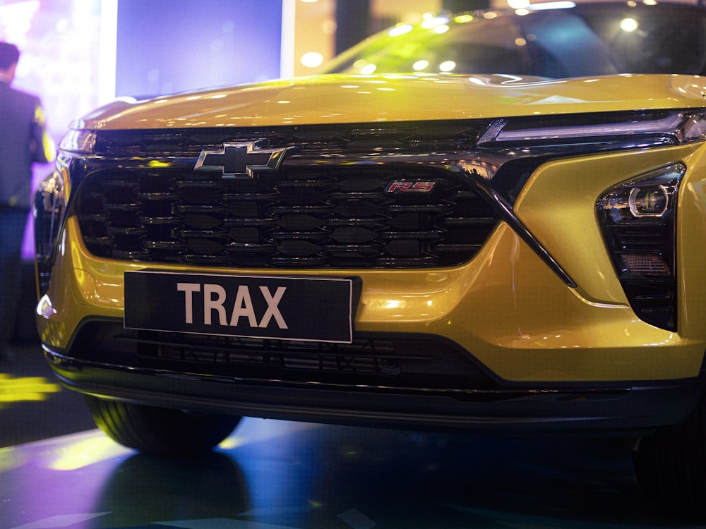 a close up of a yellow car on display