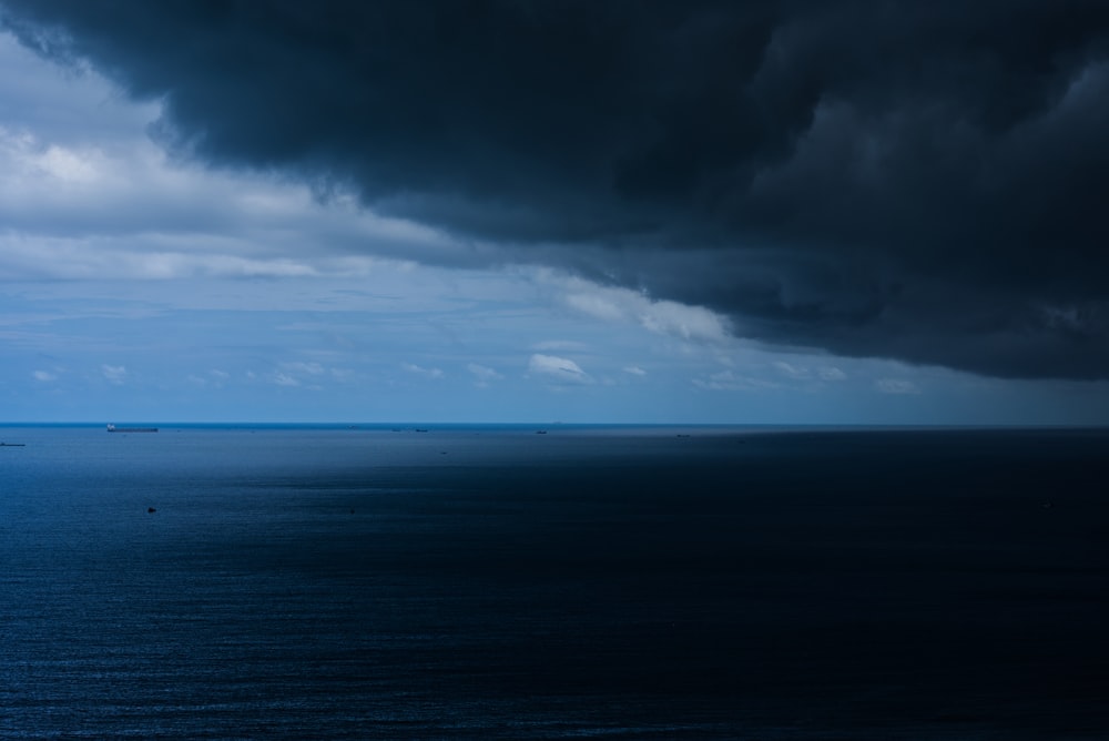 a large body of water under a cloudy sky