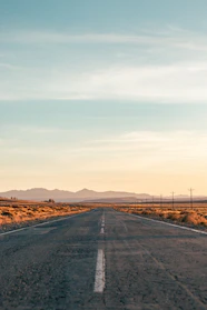 an empty road in the middle of the desert