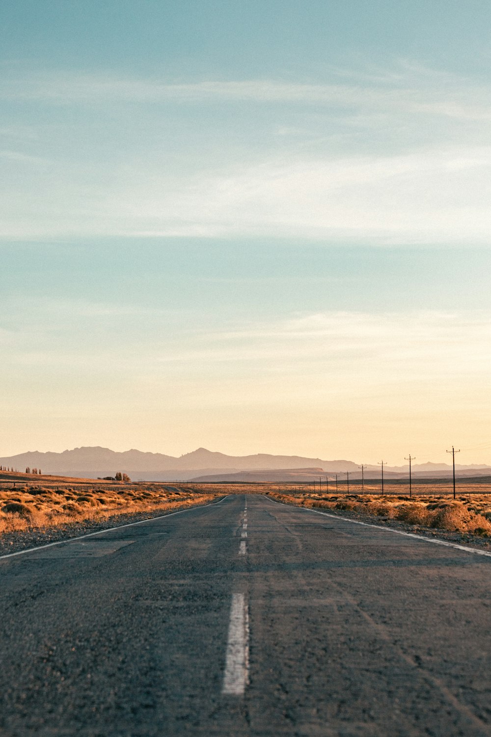 an empty road in the middle of the desert