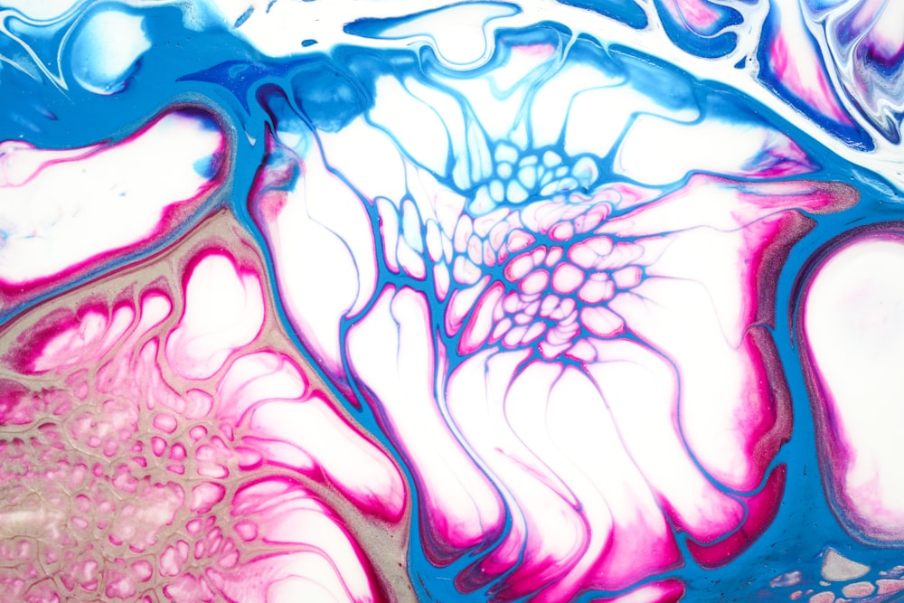 an abstract painting of a flower in pink and blue