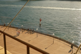 Two walkers chatting with locals along the scenic shores of Lake Geneva during a sunny day.
