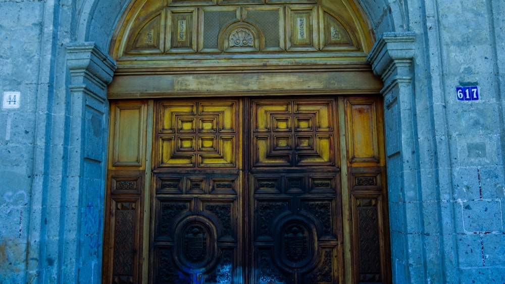 a large wooden door with a clock on it's side