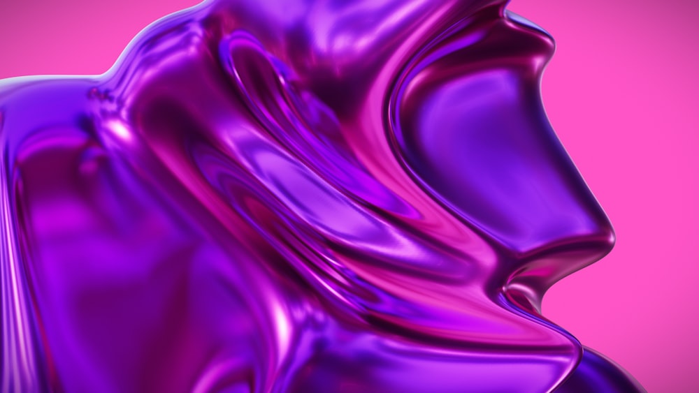 a close up of a purple object with a pink background