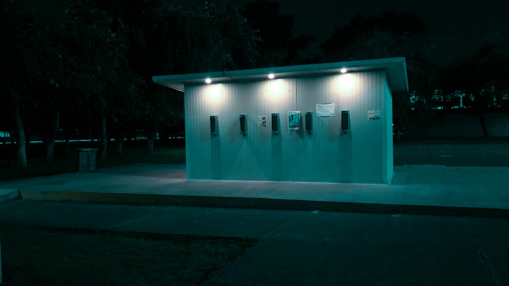 a public restroom at night with lights on