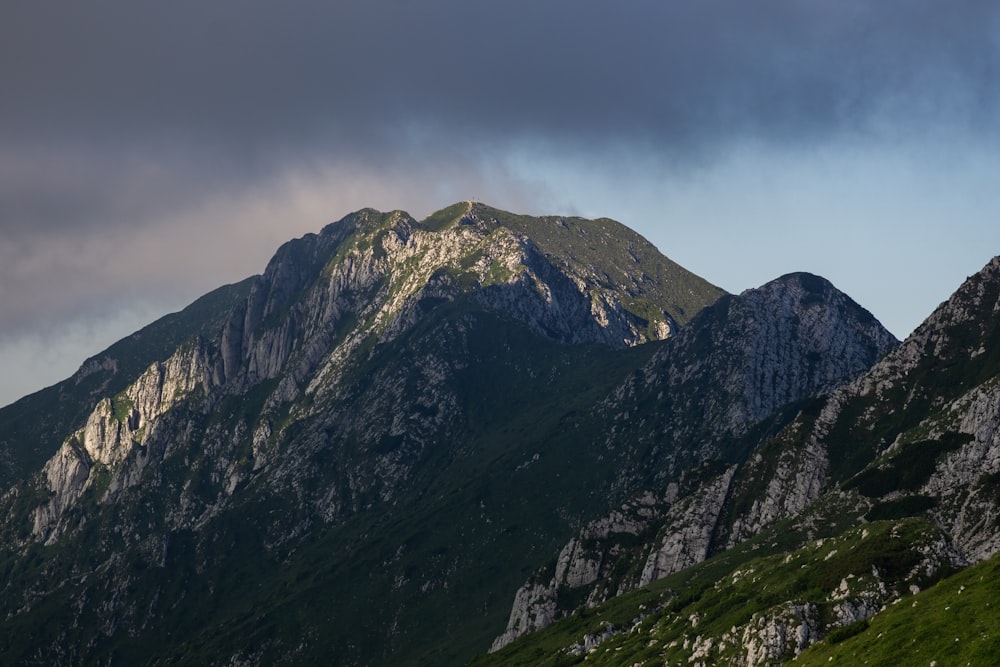 a mountain range with a dark sky in the background