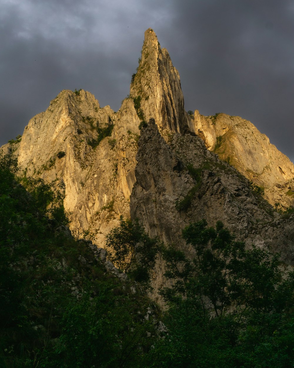 a very tall mountain with a very dark sky in the background