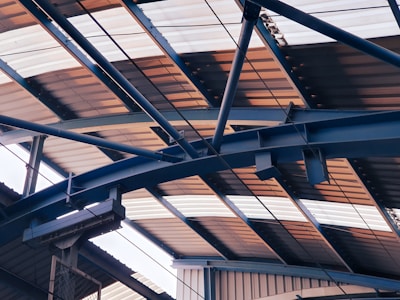Interior view of a steel workshop hangar showing strong metal beams