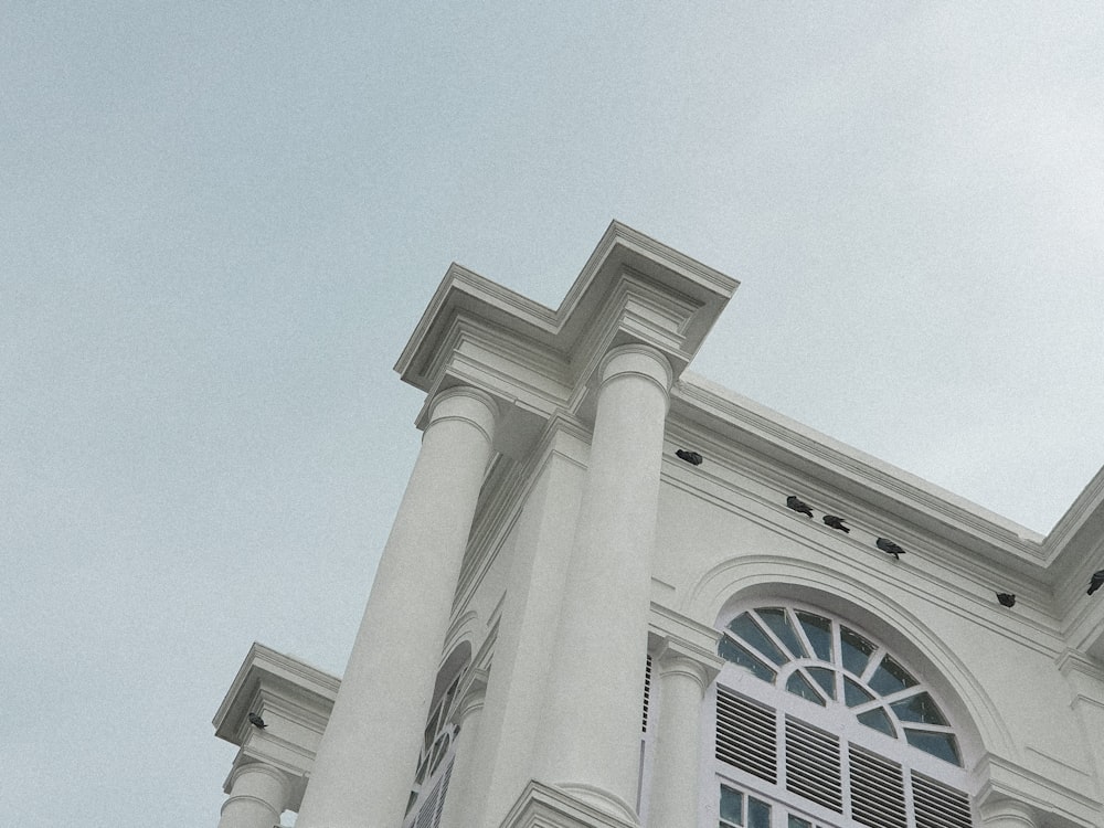 a clock on the side of a white building