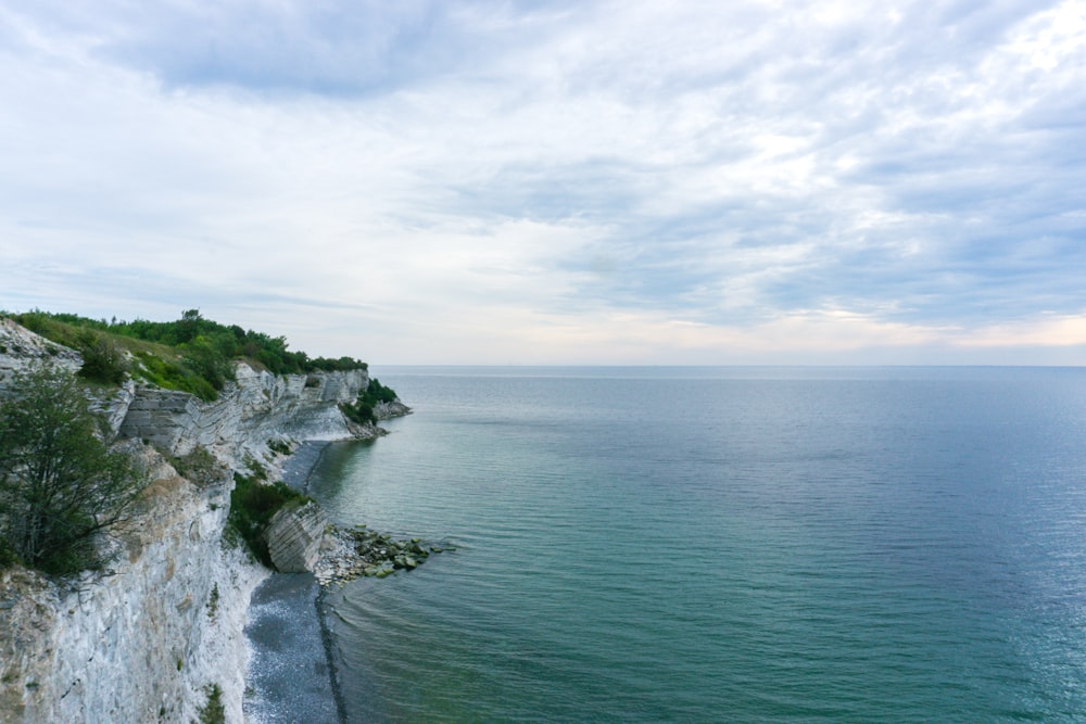 a large body of water next to a cliff