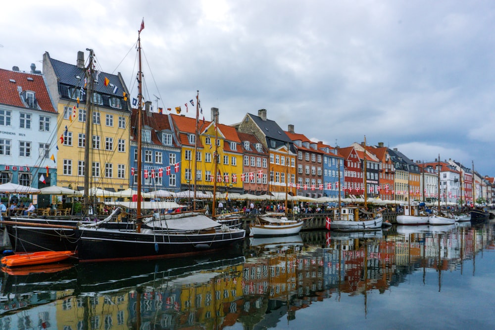 a row of boats sitting next to each other on a body of water