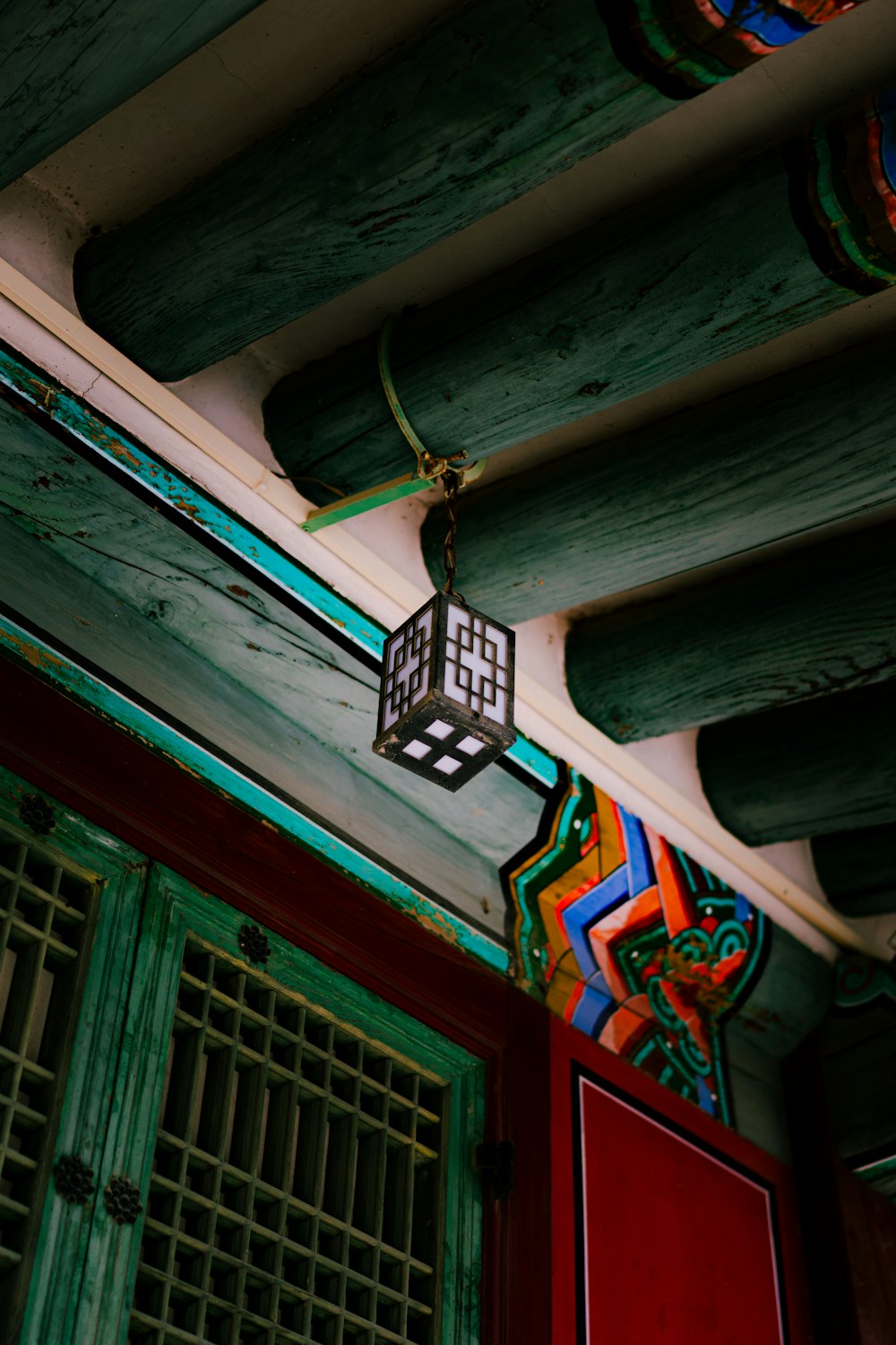 a lantern hanging from the ceiling of a building