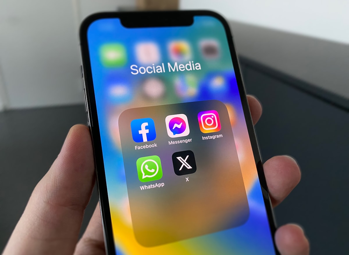 A person holding a smartphone showing a social media feed, representing Instagram's visual scroll experience