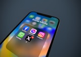 a close up of a cell phone with social media icons