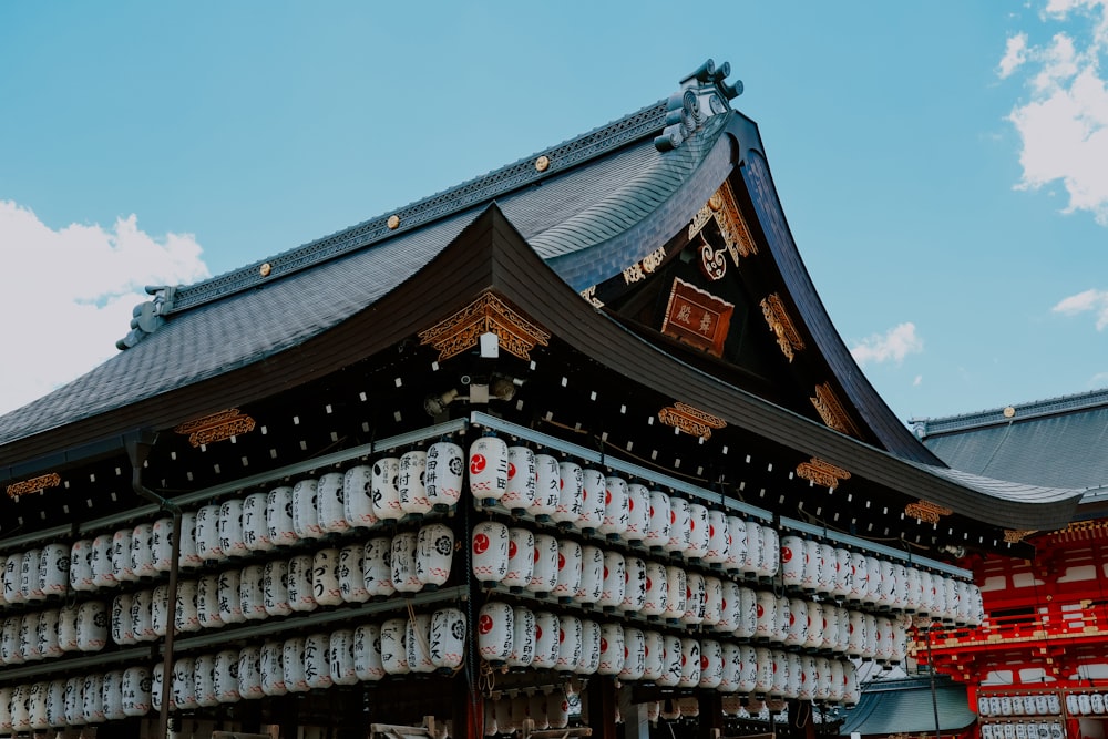 a tall building with lots of jars hanging from it's roof