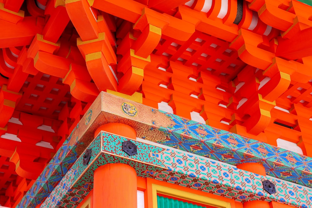 a close up of a building with many orange and blue designs