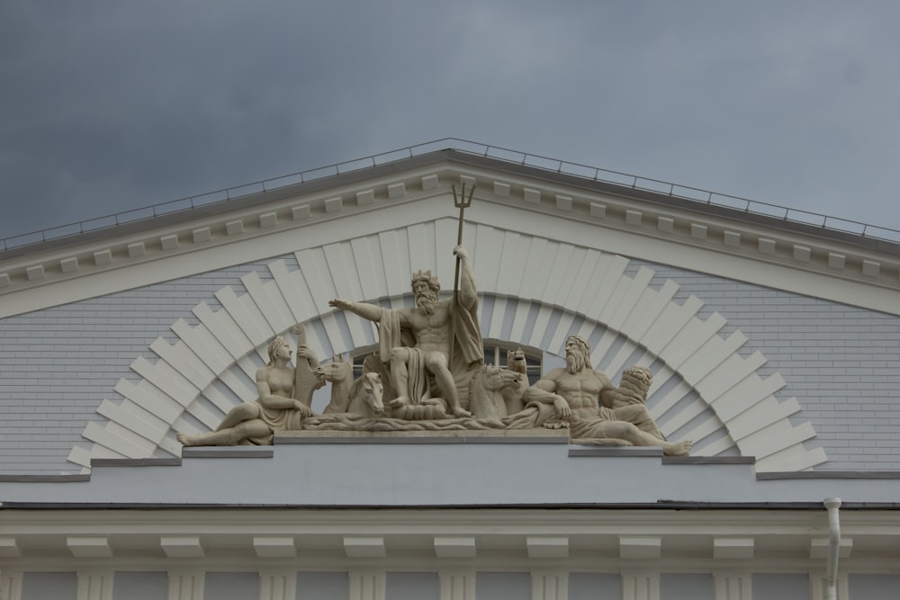 a white building with a statue on top of it