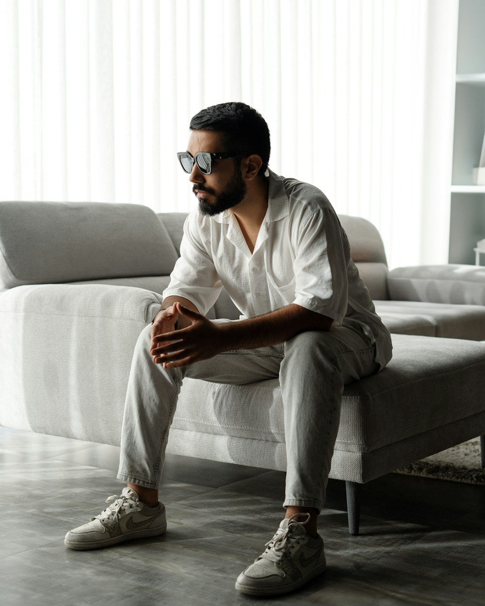 a man sitting on a couch in a living room