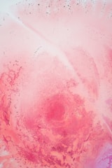 A textured canvas featuring abstract pink shapes and subtle shadows.