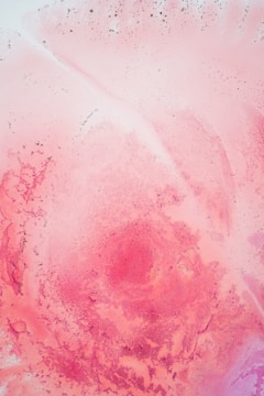 A textured canvas featuring abstract pink shapes and subtle shadows.