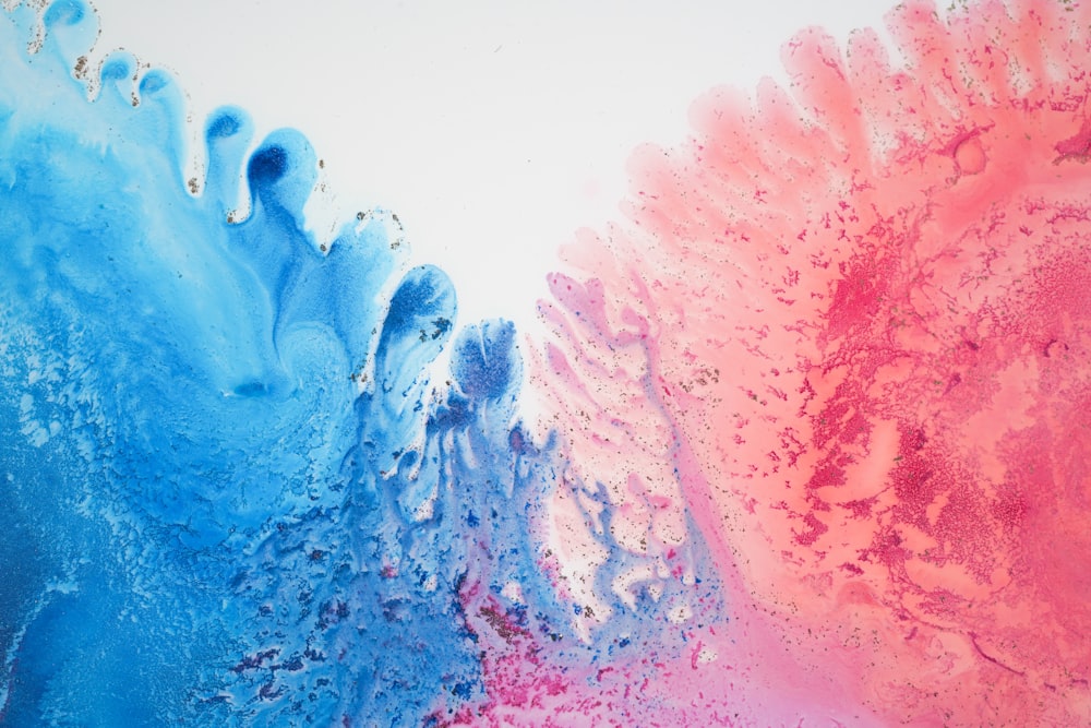 a close up of a blue and pink painting