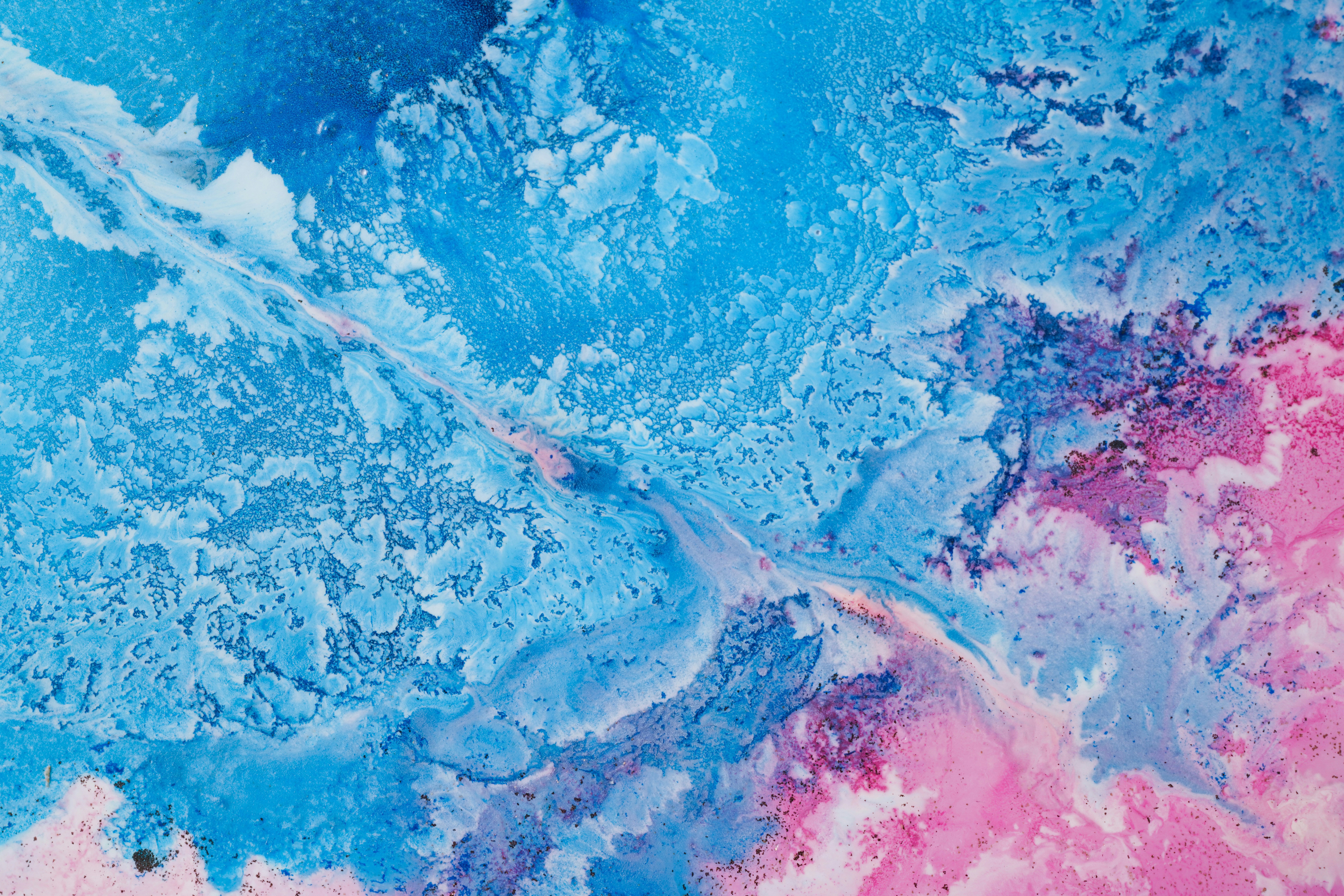 a close up of a blue and pink painting