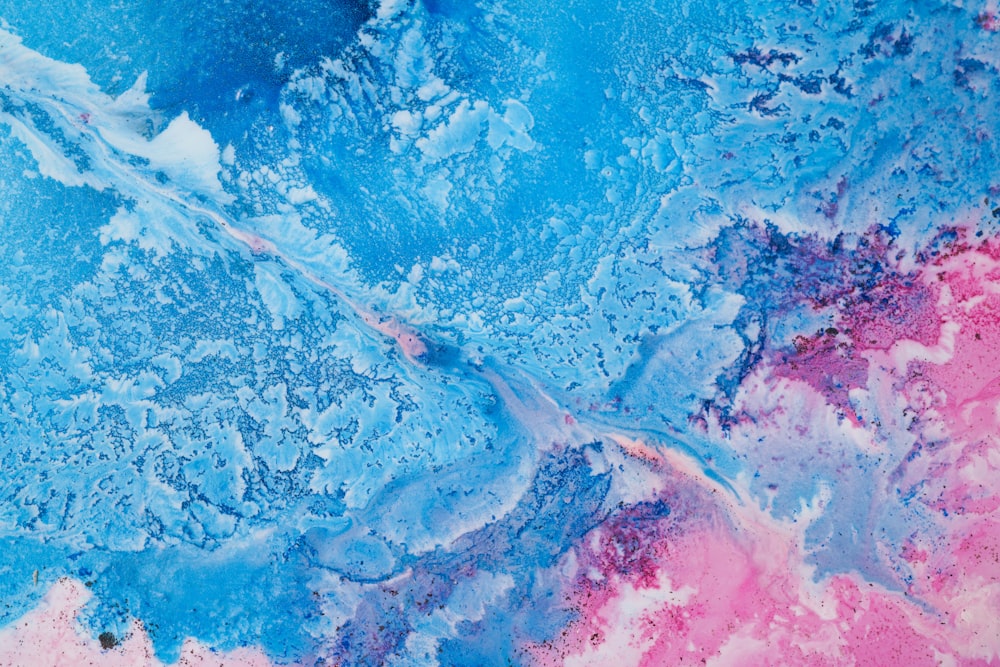 a close up of a blue and pink painting