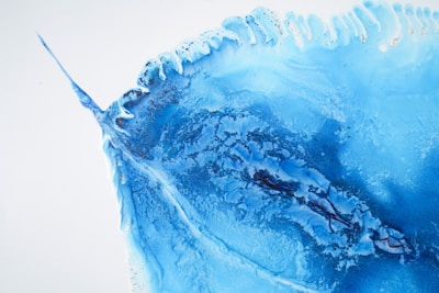 A vibrant abstract painting in various shades of blue, symbolizing security and technology.
