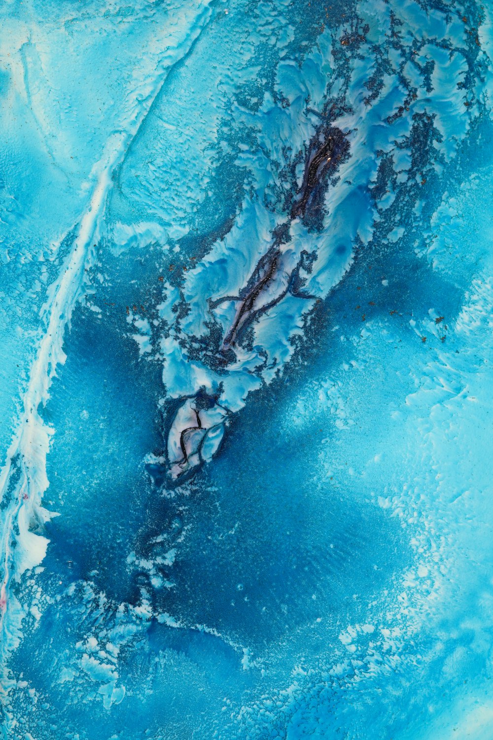 an aerial view of a blue and white substance