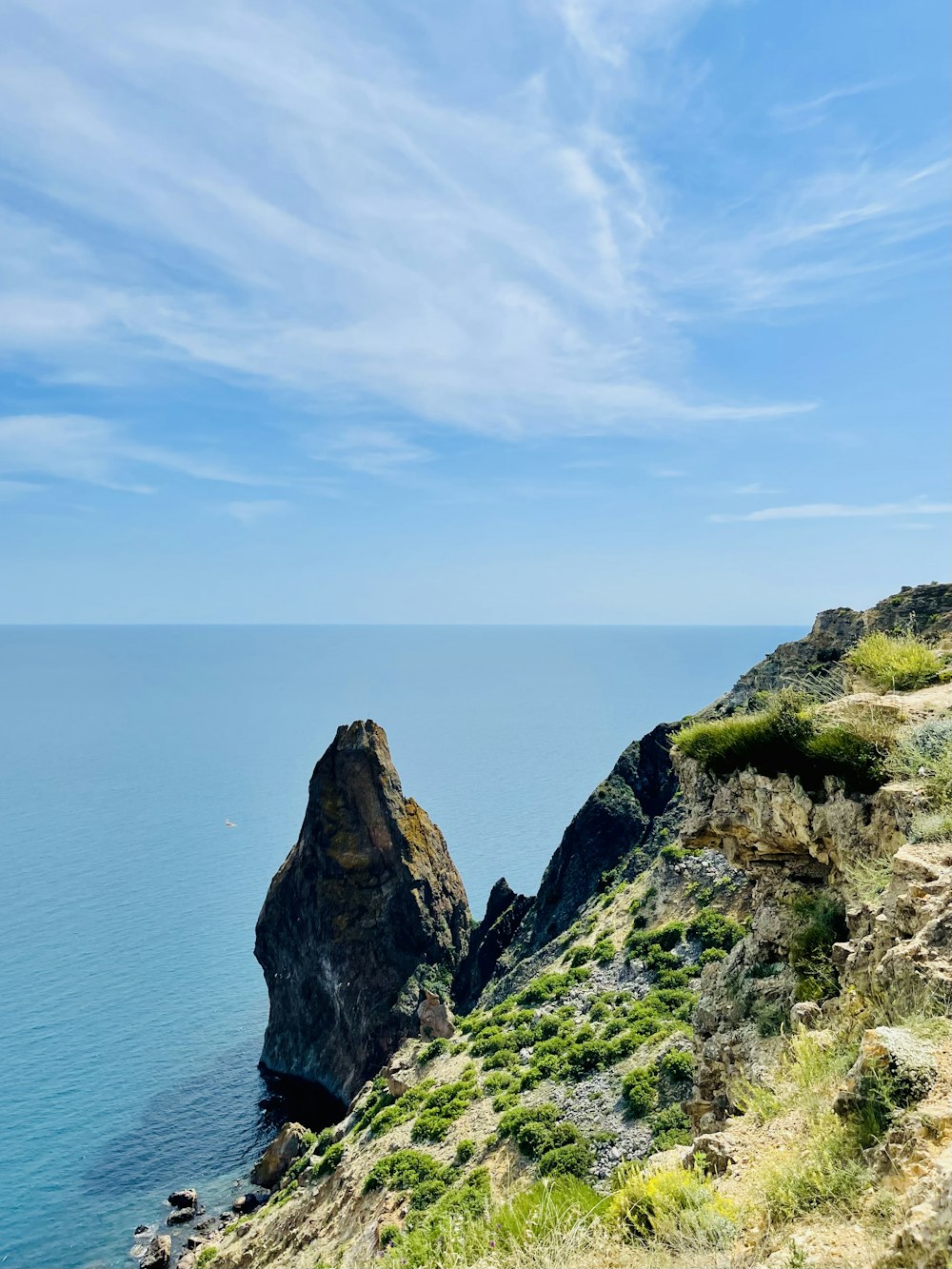 a view of the ocean from the top of a hill