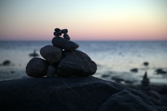 a stack of rocks sitting on top of a beach