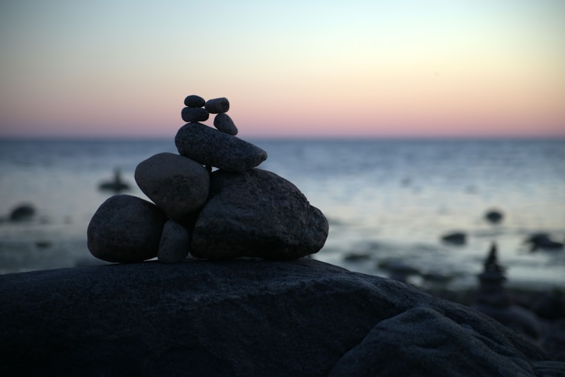 a stack of rocks sitting on top of a beach
