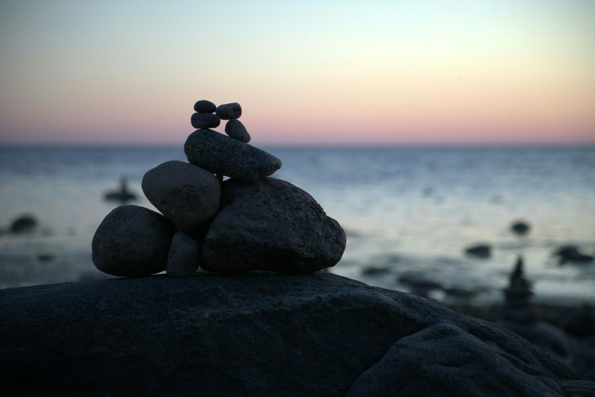 a stack of rocks sitting on top of a beach