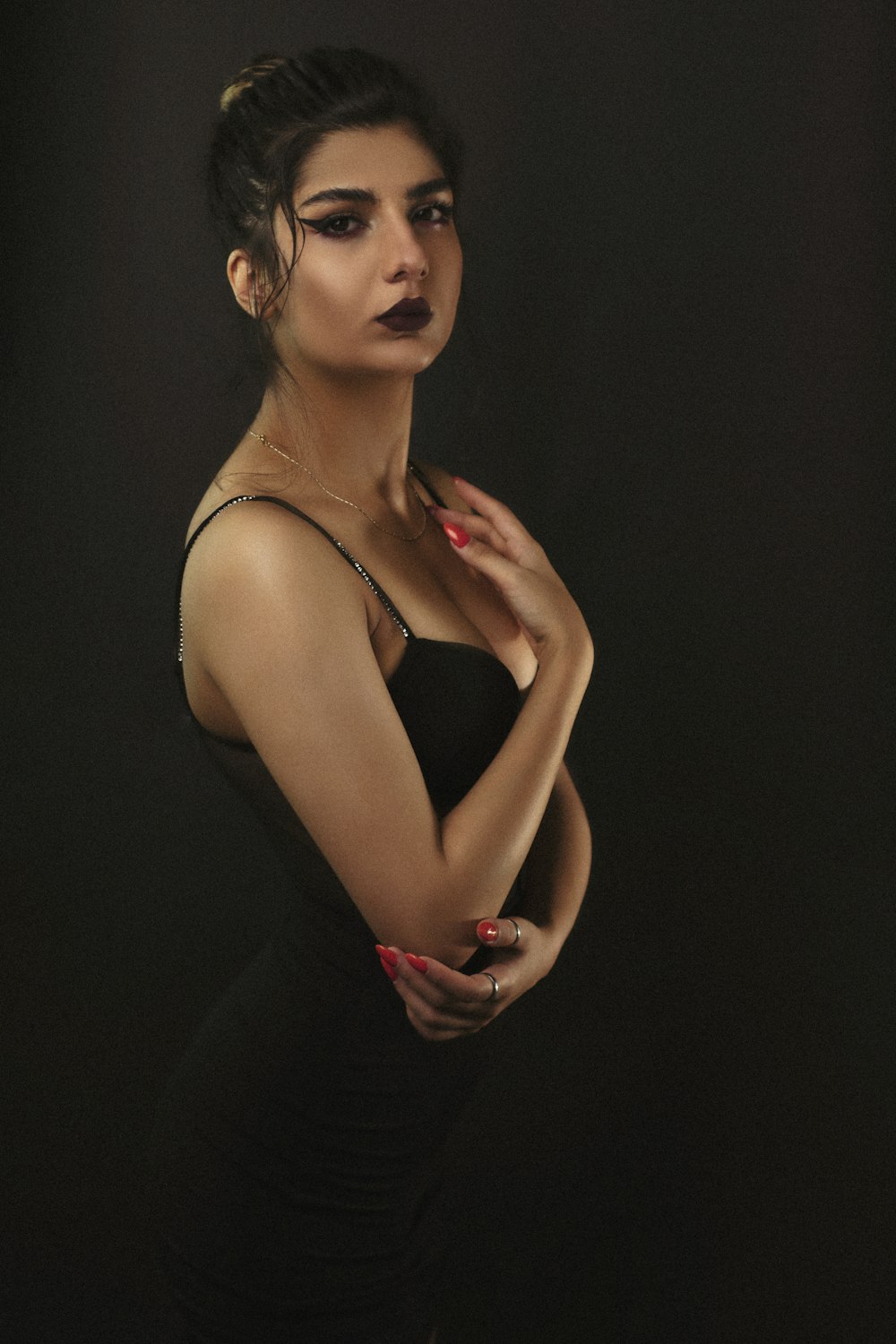 a woman in a black dress posing for a picture