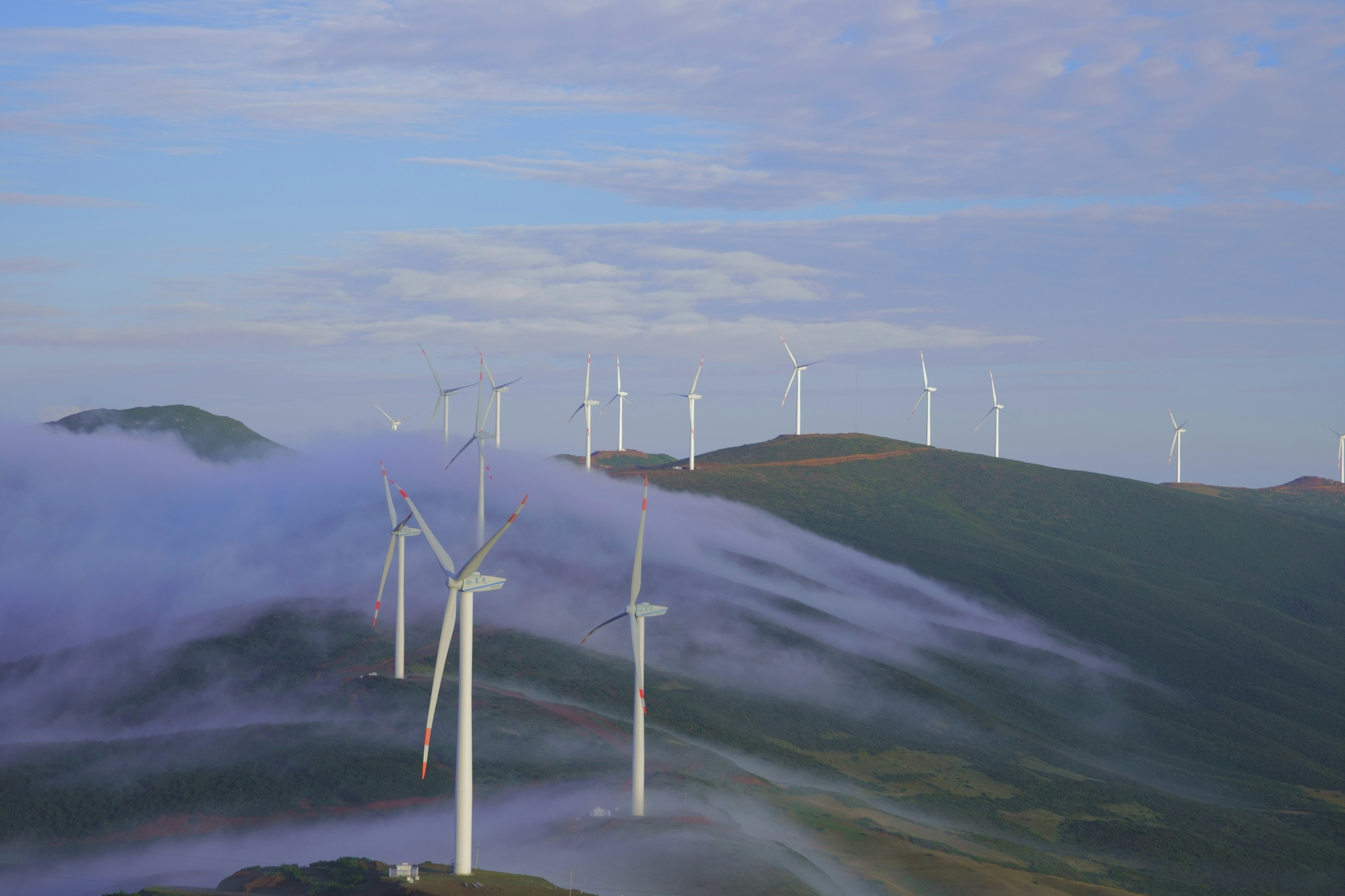 A group of wind turbines on a hill photo – Free Machine Image on Unsplash