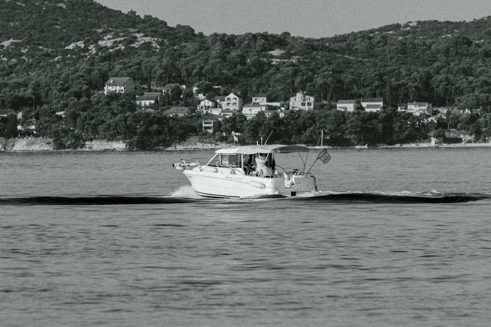 a black and white photo of a boat in the water