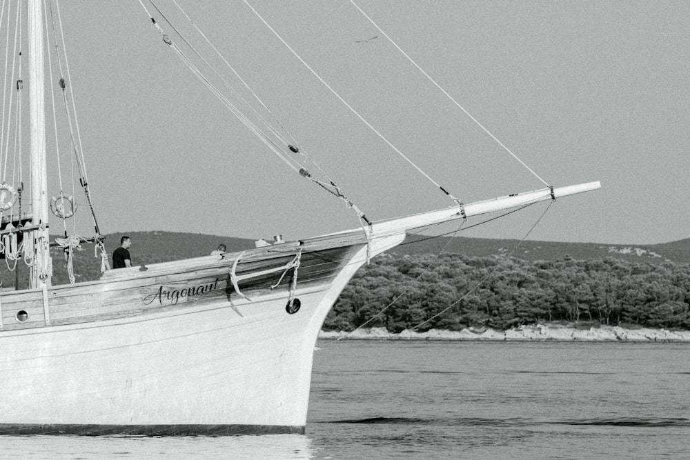 a black and white photo of a boat in the water