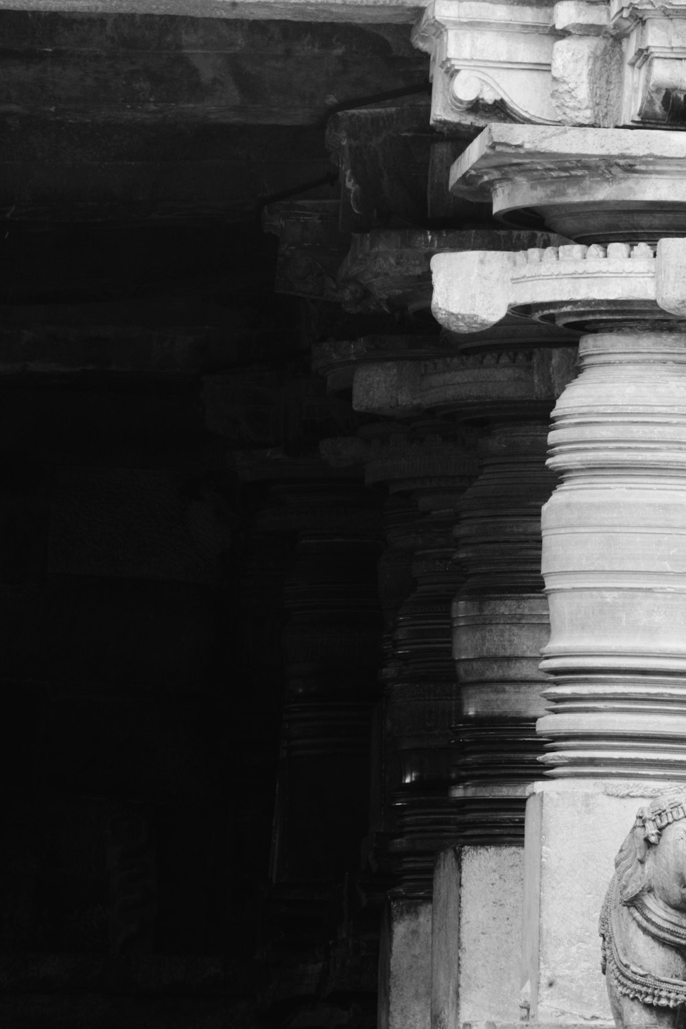 a black and white photo of a stone pillar